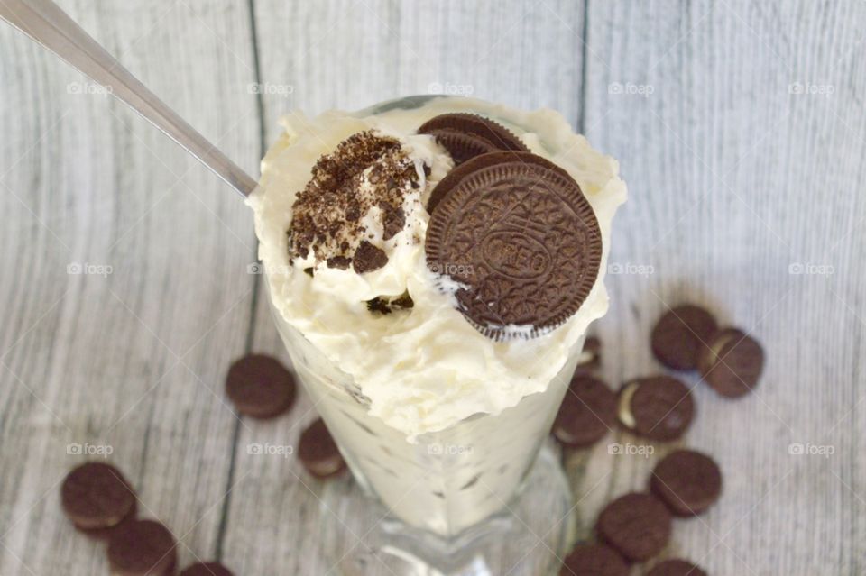Oreo cookie milkshake with a wooden rustic white background