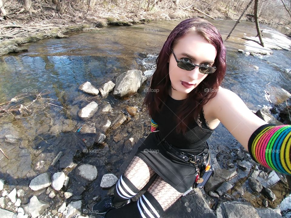 goth girl sitting by water