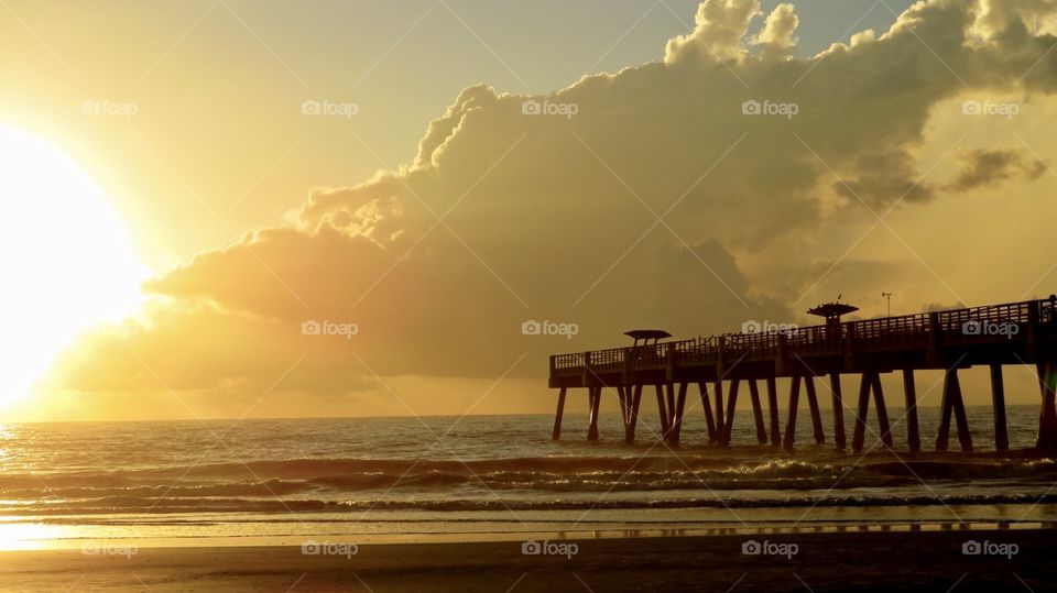 Sunrise at the pier on the beach