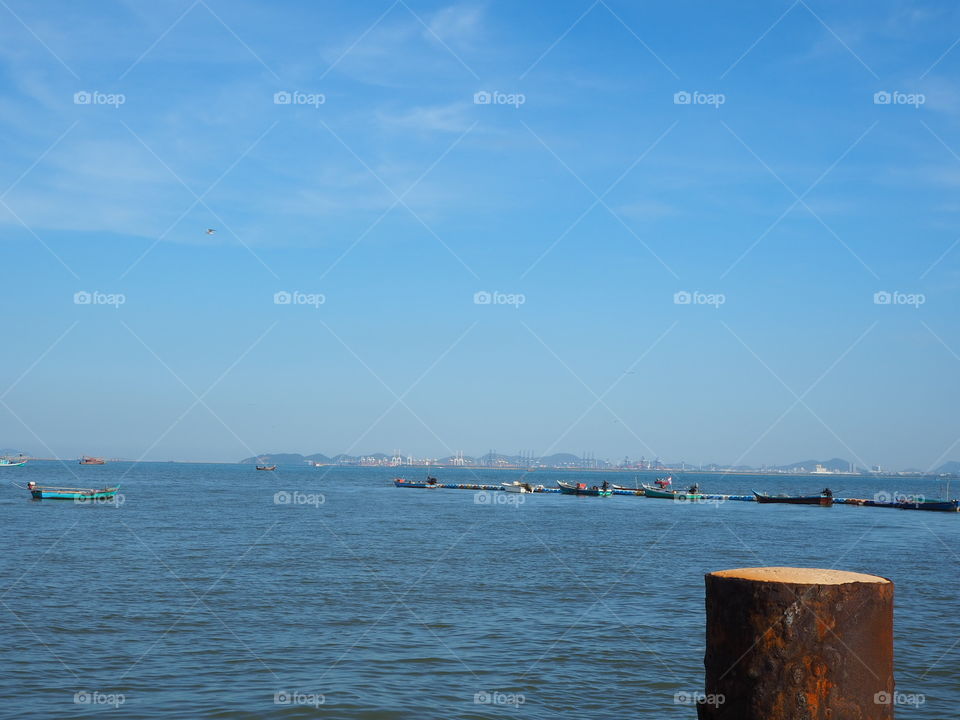 Boats in straight line at nearby harbor before departing for fishing trip.