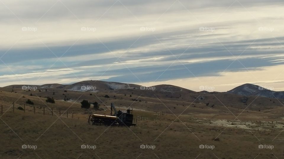 early morning farm equipment in a field