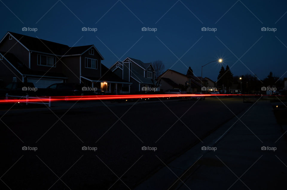 Slow shutter speed of a car passing in our street