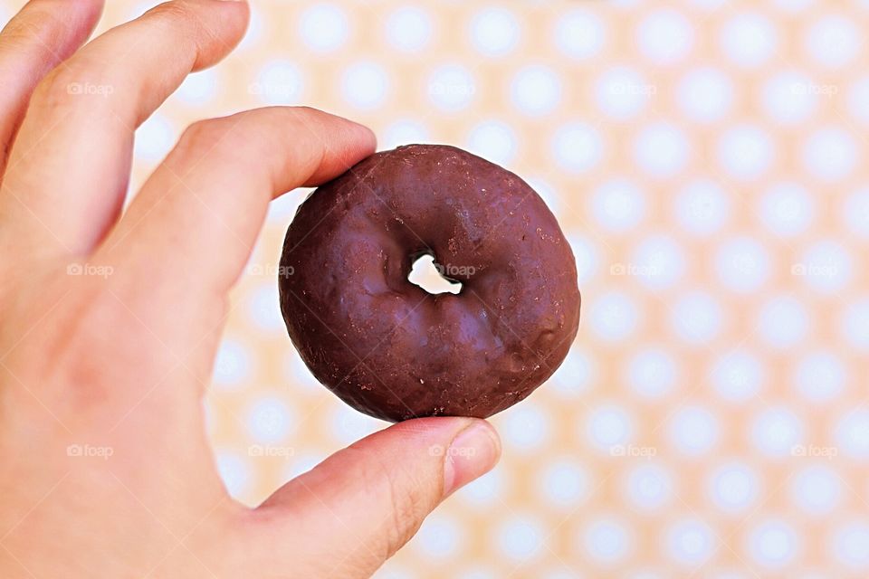 Hand holding mini doughnut