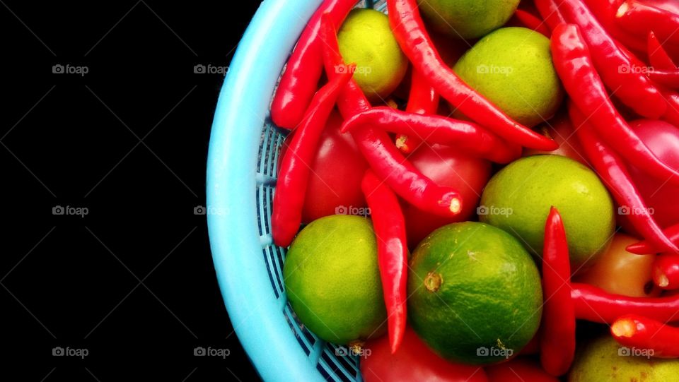 Colorful fresh chili and lime in the basket