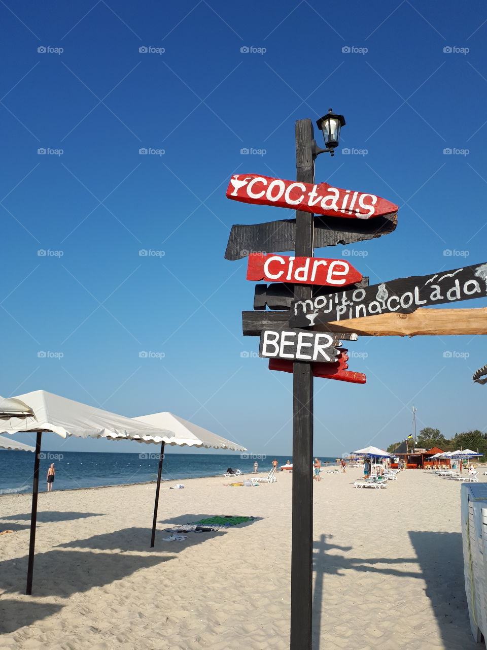 Street signpost at the beach. Beach bar