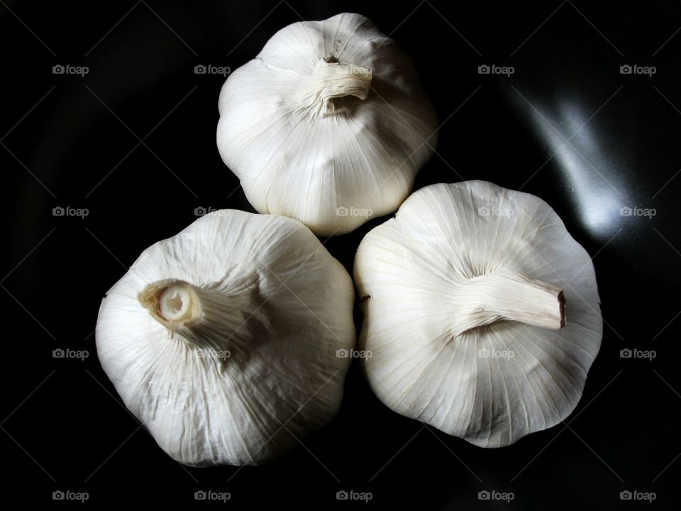Garlic bulb on black background