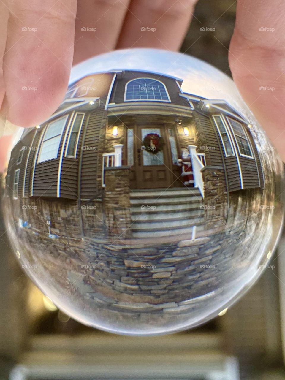 Welcome to Christmas; Globe photo of a Christmas Decorated front door with Santa Clause