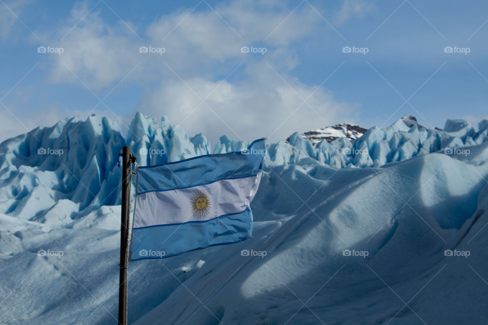 argentina flag in perito moreno glacier