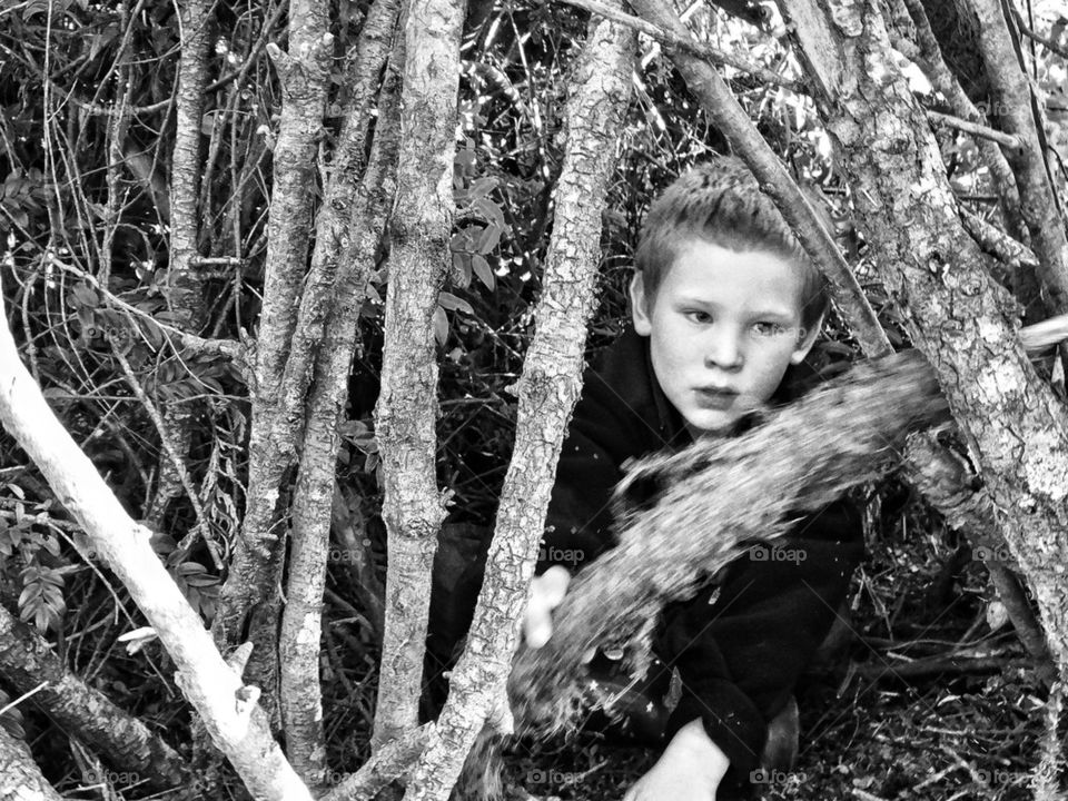 Boy Hiding in the Woods