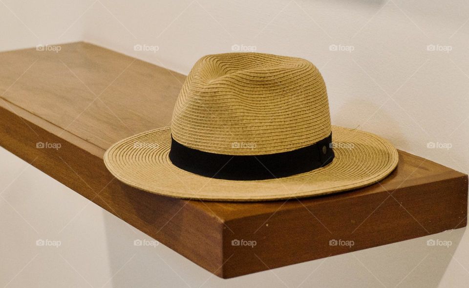 Classic sun hat on a shelf.