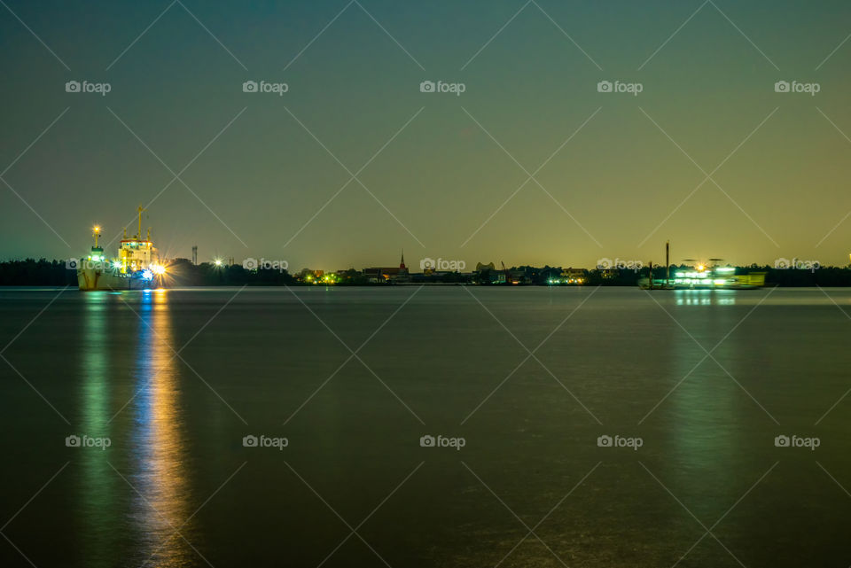 Light of ship reflect on river