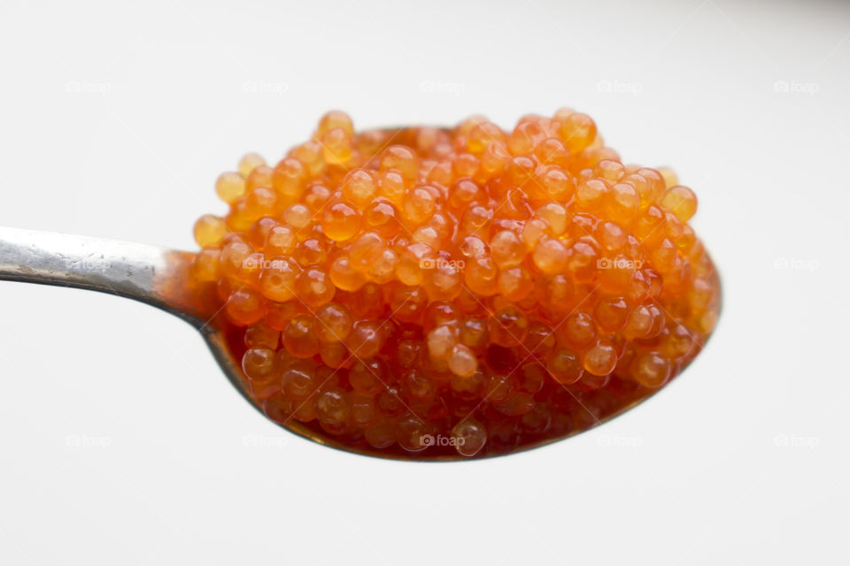 Orange caviar on a spoon 