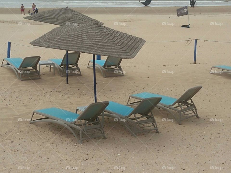 Beautiful seats under umbrella.