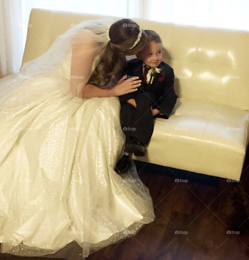 Bride kissing cute little boy