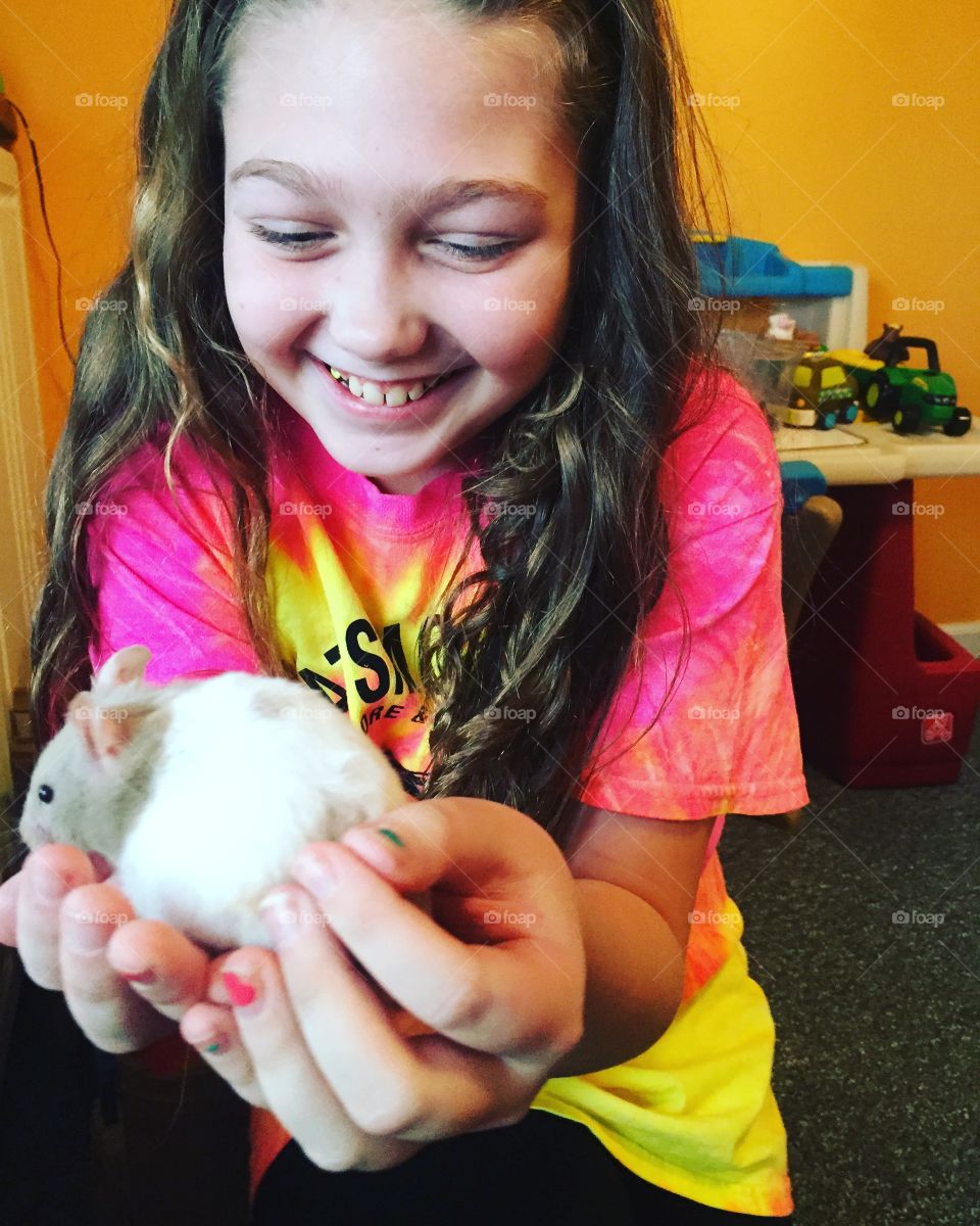 Smiling girl holding mouse