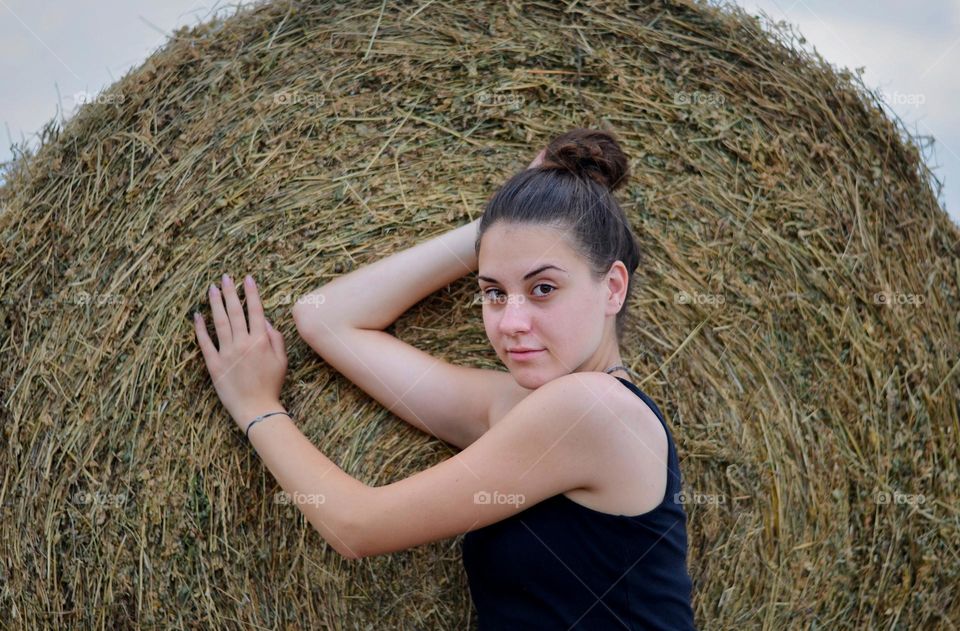 Portrait of Beautiful Young Girl on Straw Bale