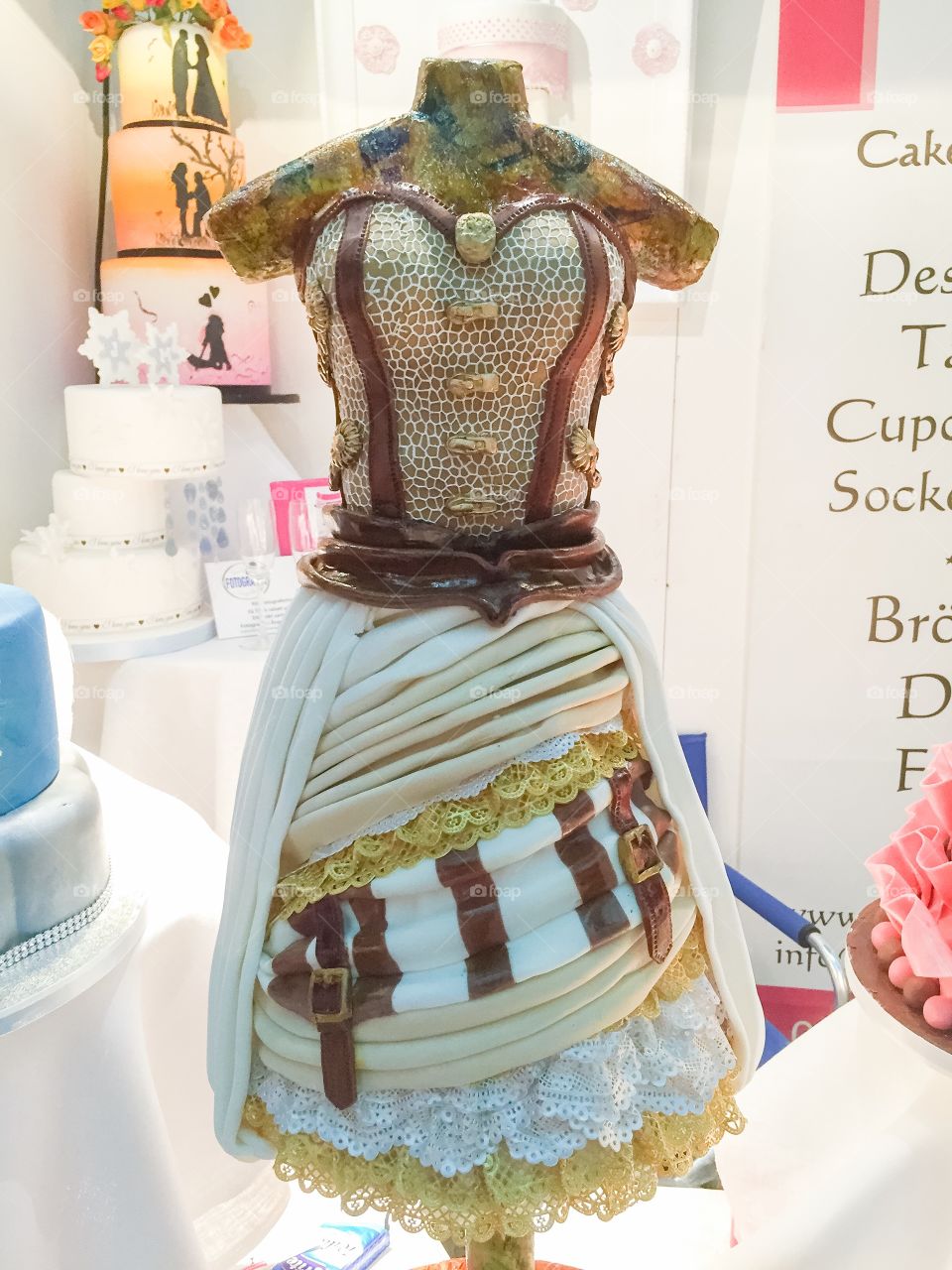 A very different weddingcake in the shape of a dress.