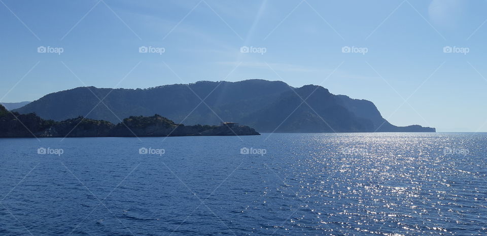 Ocean with a mountain backdrop.