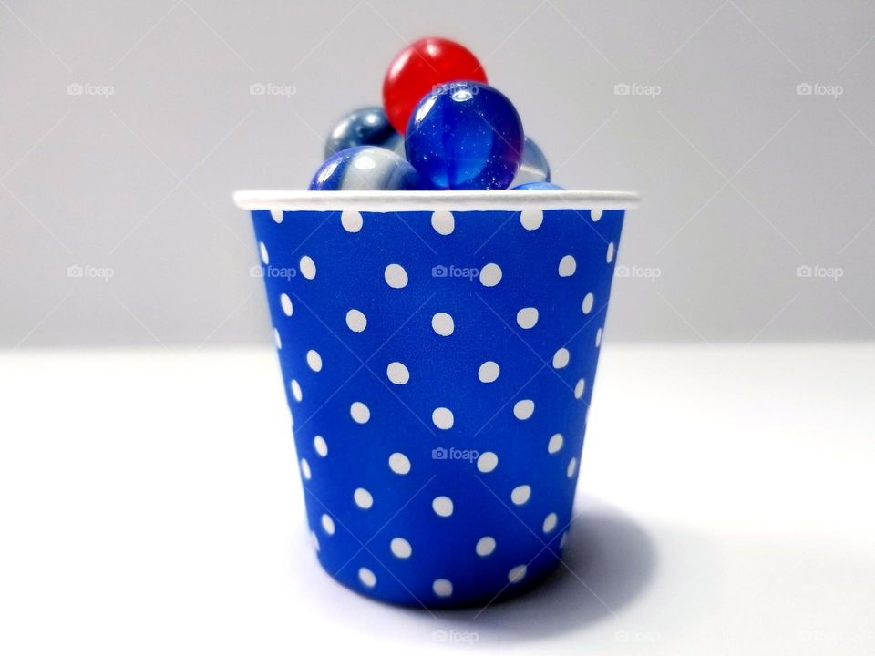 Royal Blue Polka Dot Paper Cup with blue marbles & a red marble like a cherry on top