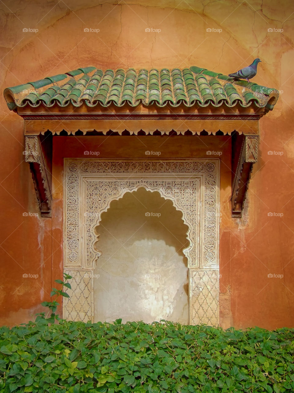 Mysterious gate to nowhere. Decorative feature in earthy colored wall. Marrakesh. Morocco.