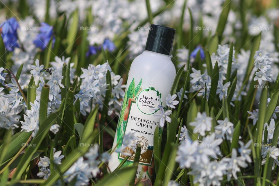 Herbal Essences detangling cream amongst flowers