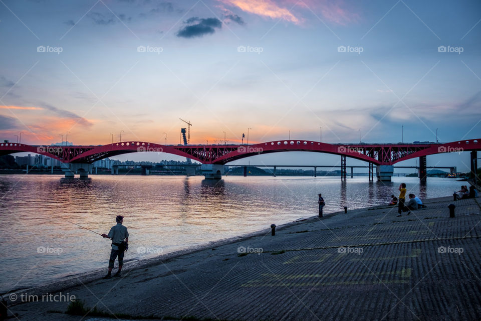My last night in Seoul - a fisherman notes the sunset behind a bridge