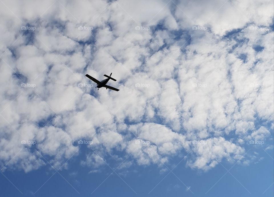 Cloudy sky and flying airplane