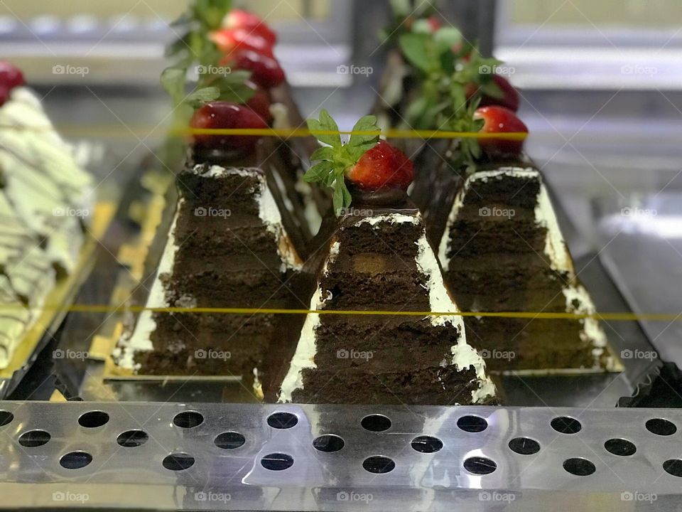 Cream and chocolate pyramid with strawberry 