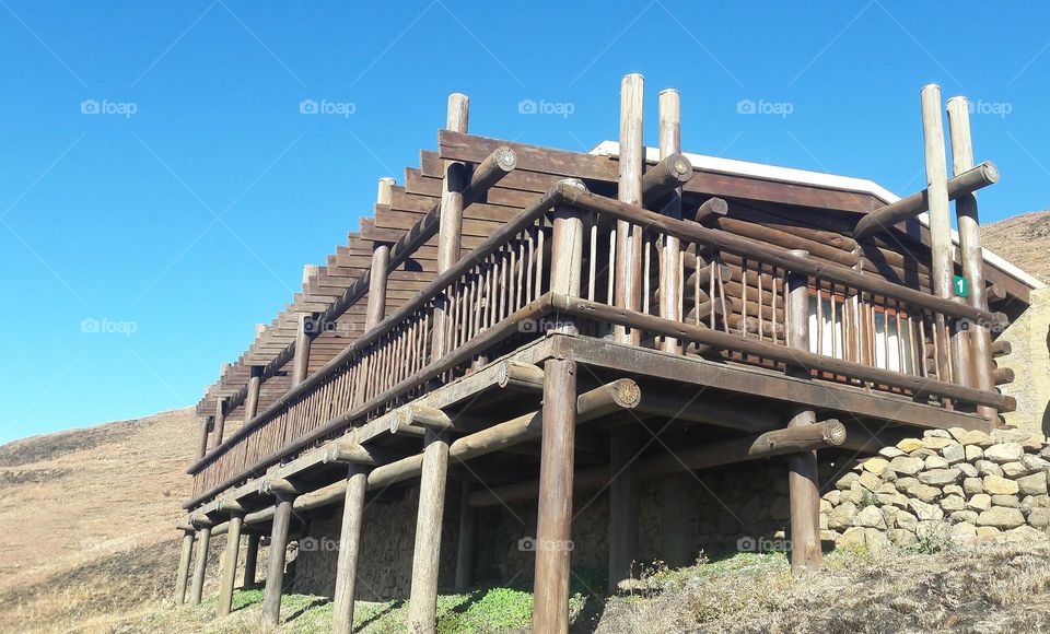 a cabin on the hill and blue sky's