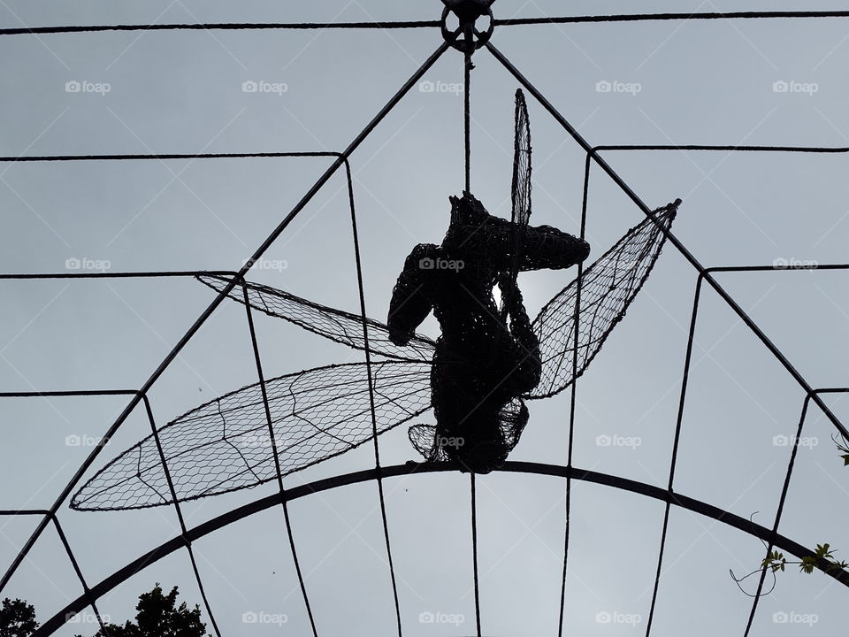 Wire spider fairy from on a dark sky background