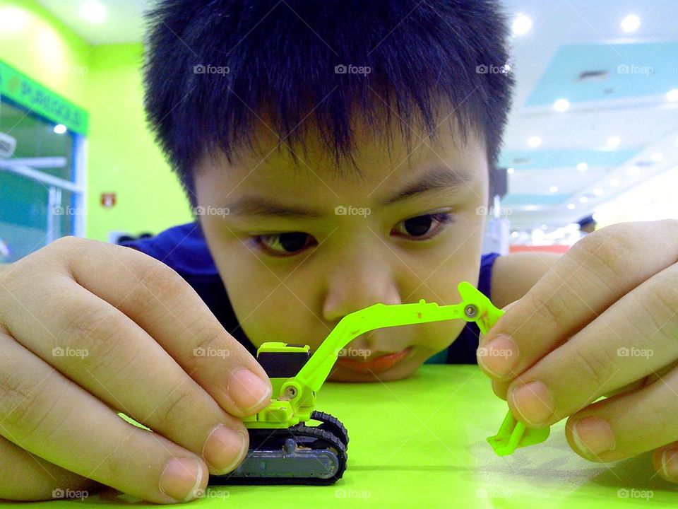 boy playing with a toy backhoe