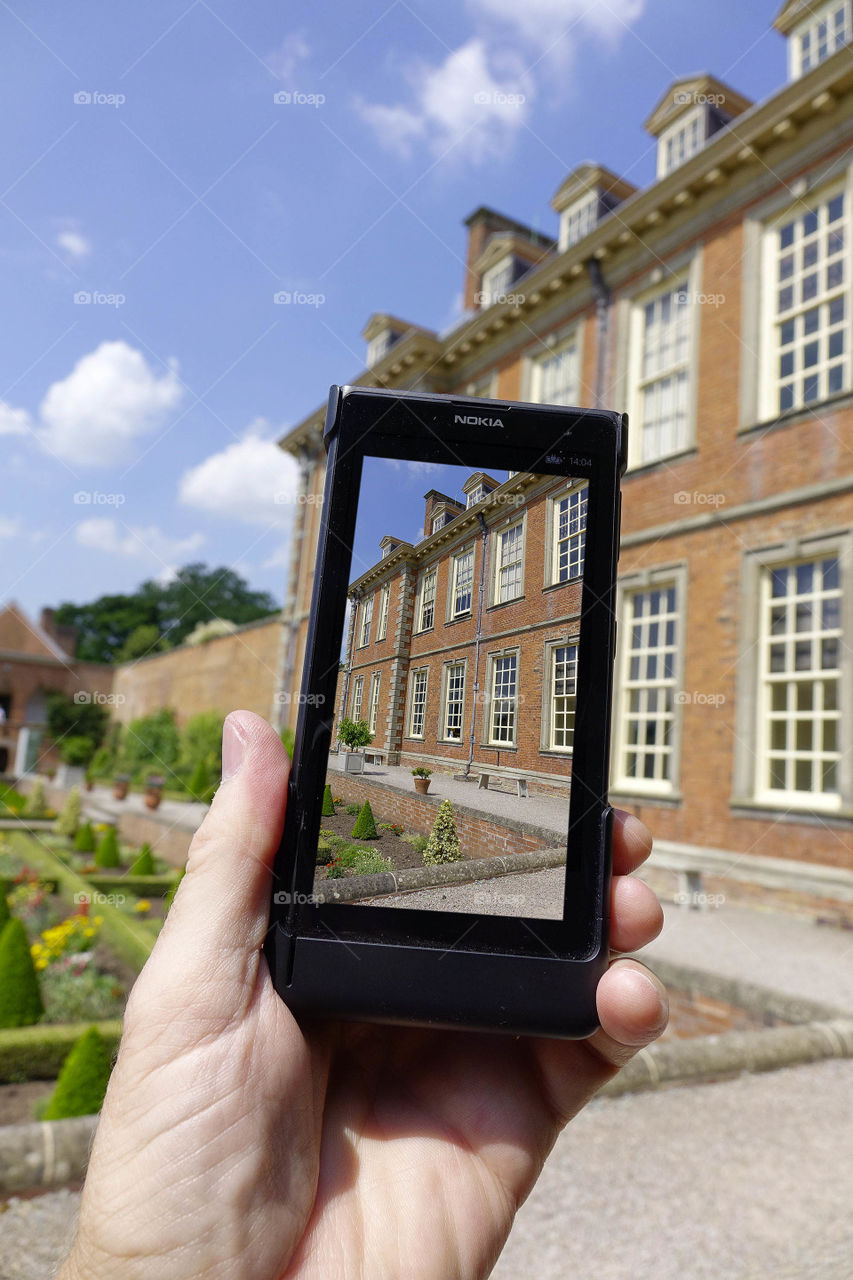 Camera phone. Taking a picture of a garden in an English stately home with a smartphone cell phone mobile phone camera 