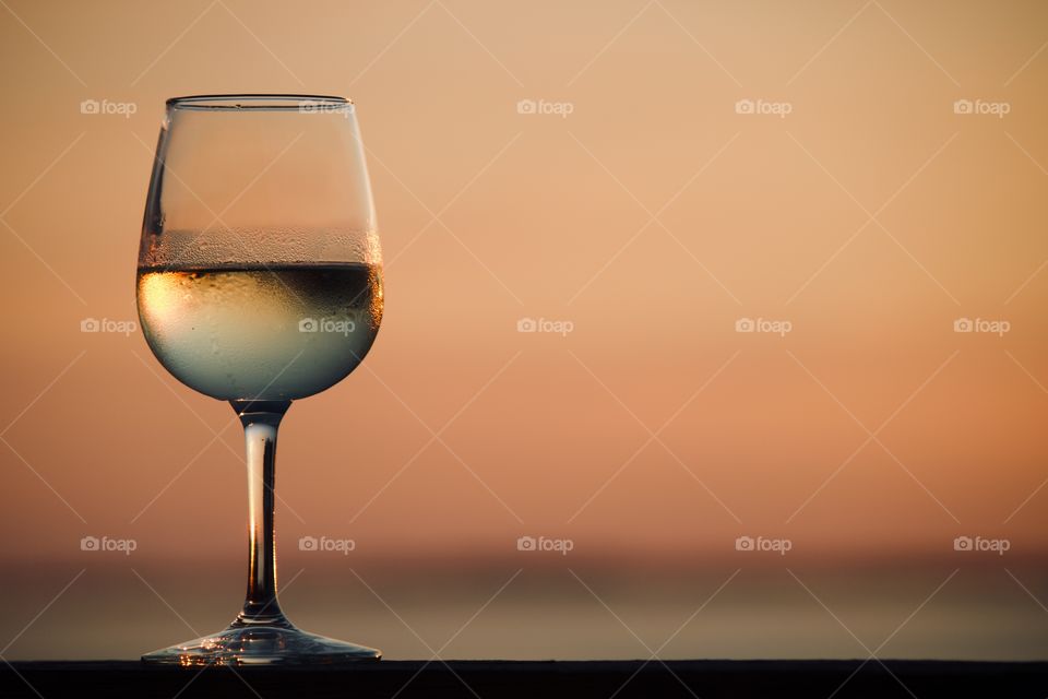 Glass of wine at sunset 
