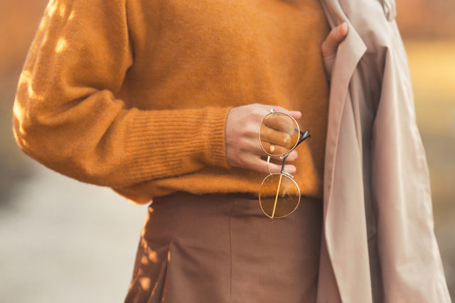 Autumn fashion details. Closeup photo of woman’s clothing in fall season colors