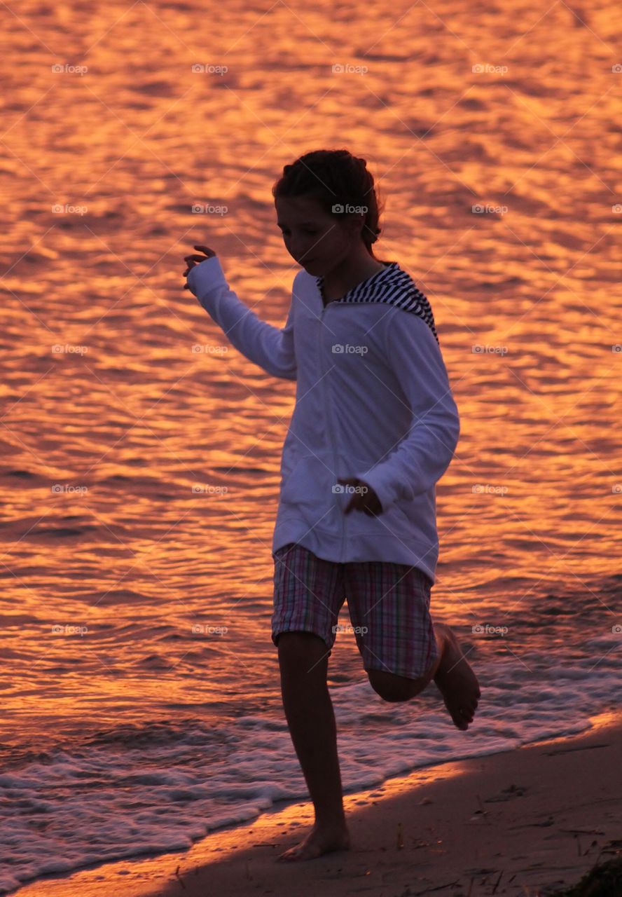 Running.... Running along the beach at sunset, she never sits still - running mission
