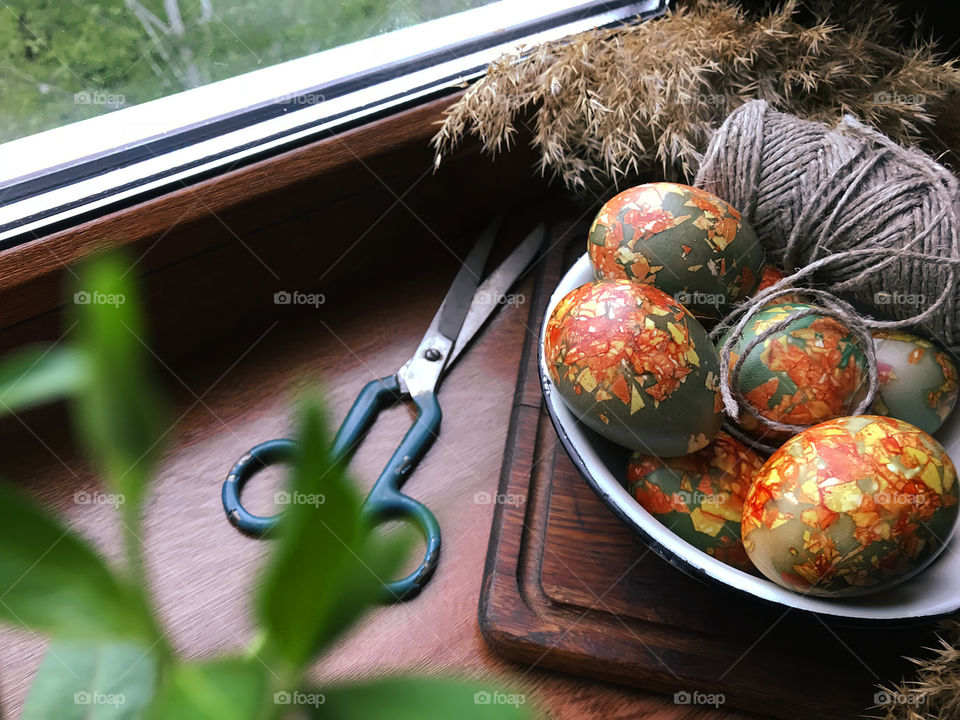 Marble Easter eggs on rustic wooden window 