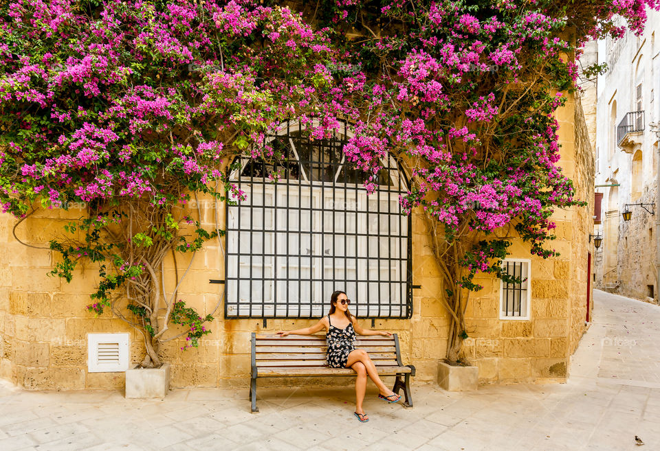 Elegant woman sitting on bench