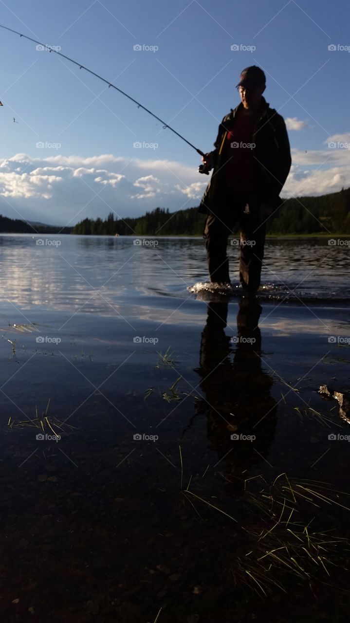 Man fishing in lake