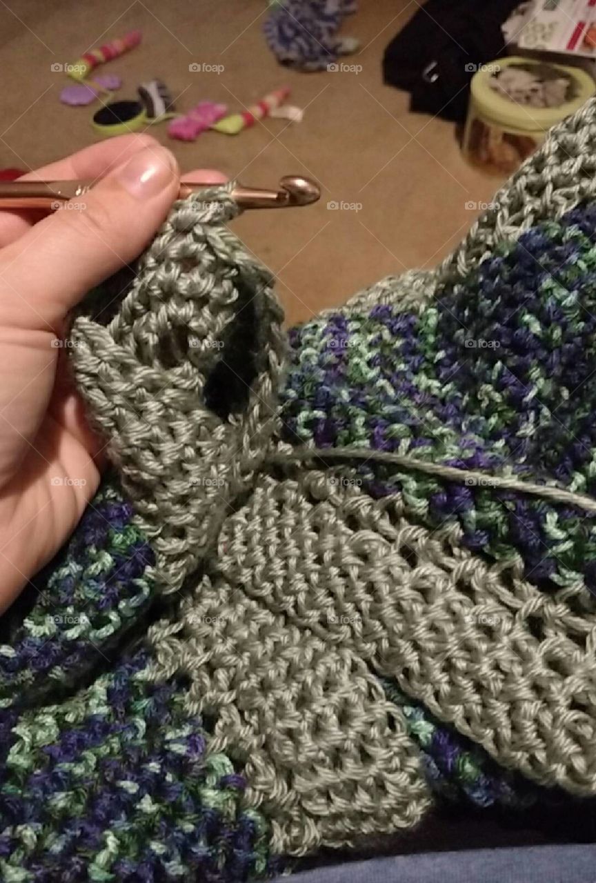 A blanket being crocheted.