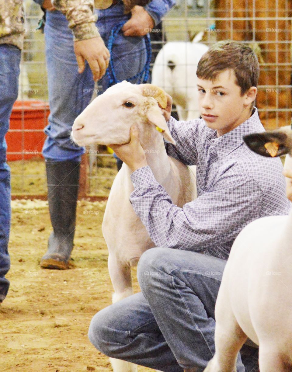 Teenage boy with goat