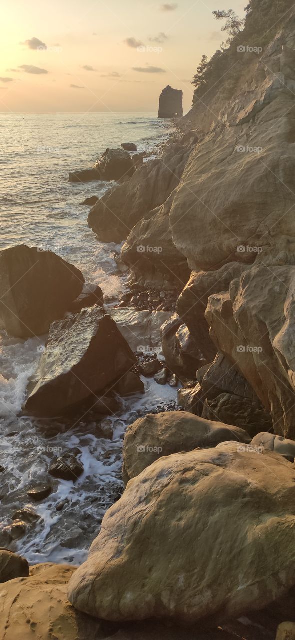 Rocky coast of the Black Sea in the rays of the setting sun