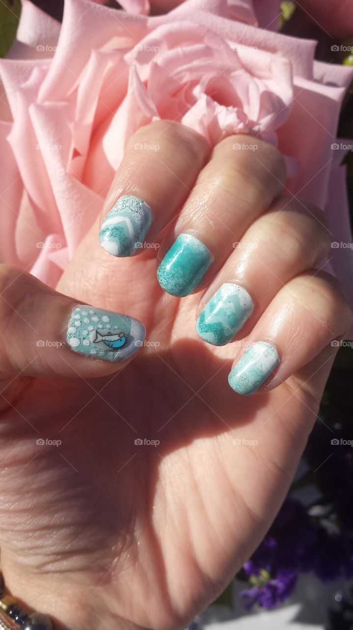 Teal nail art polish cute design, flowers in background, pink rose, flower arrangement