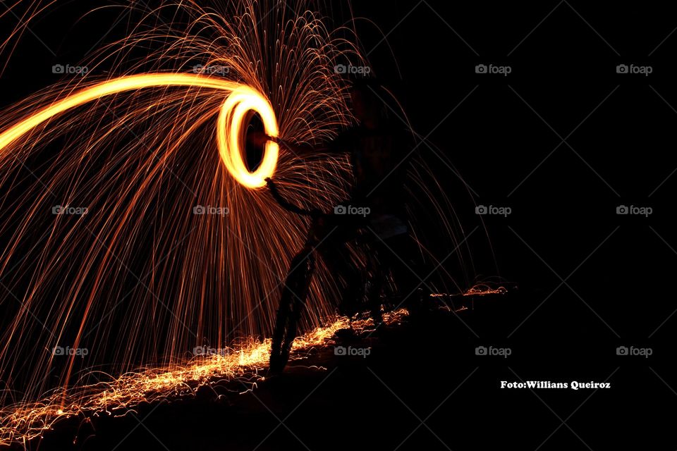 Man twirling fireworks at night