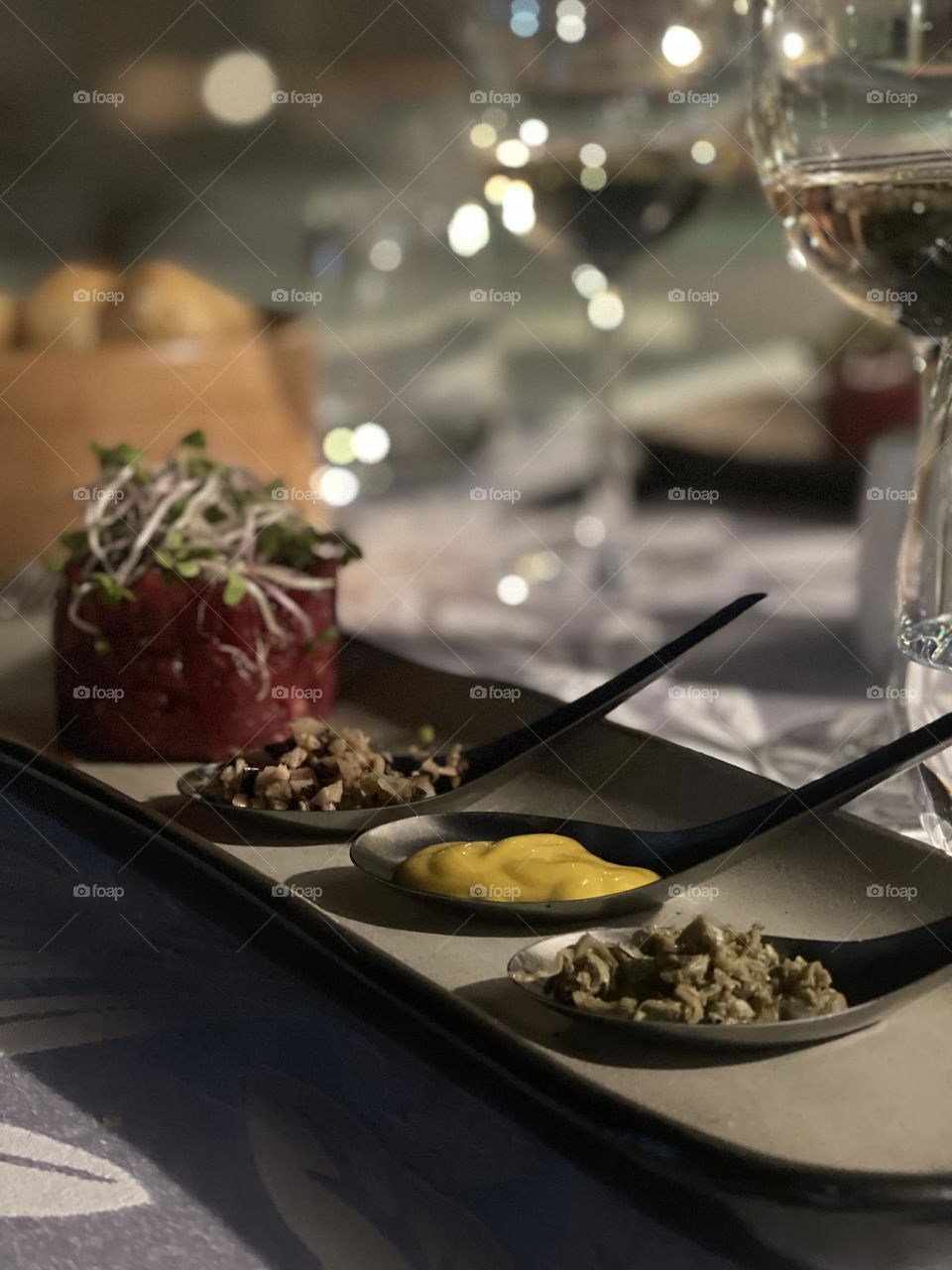 Beef tartar in the restaurant. Raw meat with capers, mustard a la carte