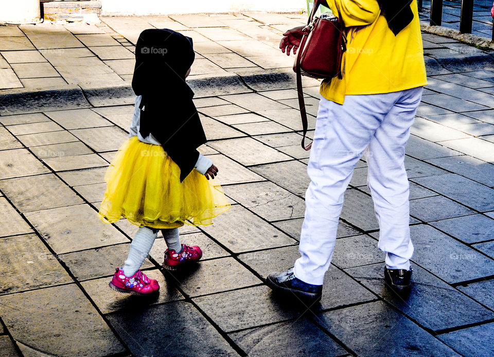 The little girl with her mother, was on vacation somewhere. Seen the girl is very cute