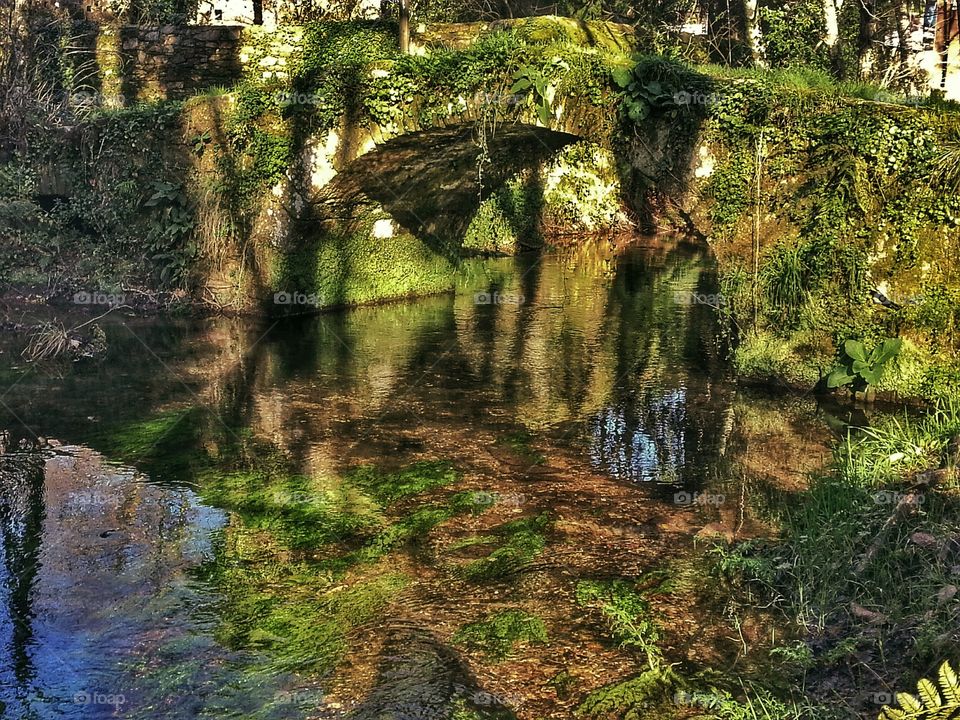 Light and shadows on old stone bridge. Old stone bridge, Santiago de Compostela