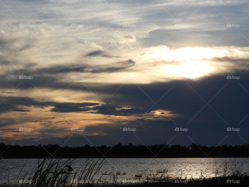 Cloudy Sunset Over A. Lake 