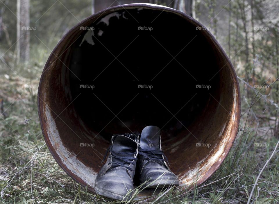 Shoes and circle pipe tunnel in the forest