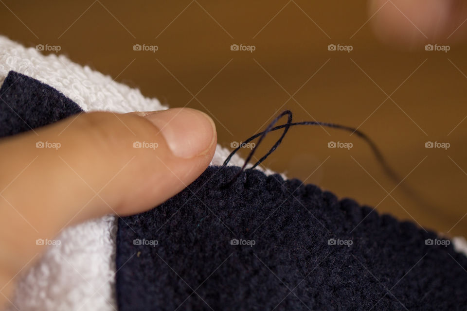 Sewing a towel with blue thread