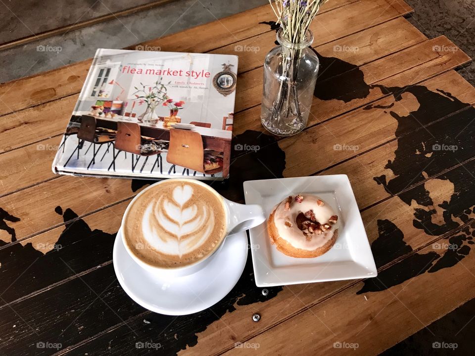 Coffee and doughnut with coffee table book